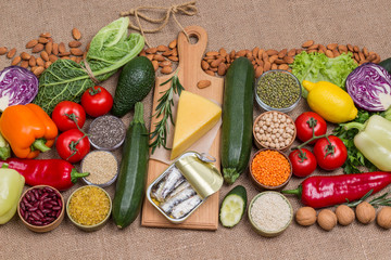 Concept of healthy eating and longevity. Food sources of omega 3, protein. Healthy food for diet and lifestyle: cheese sardines, leavy vegetables, beans nuts, quinoa bulgur, chickpeas, flax almond.