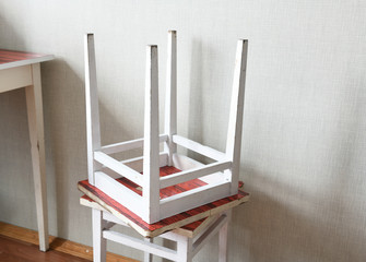 Old two stools are on the floor of linoleum