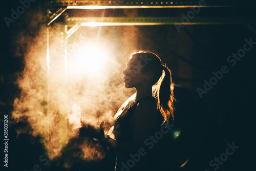 Young athletic woman preparing hands for hard training with sport equipment. Closeup of female hands with talc powder.