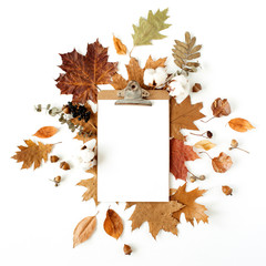 Wall Mural - Blank sheet clipboard with empty mockup copy space for text. Cotton buds, acorns, dry leaves on white background. Flat lay, top view template for social media, blog, magazine.
