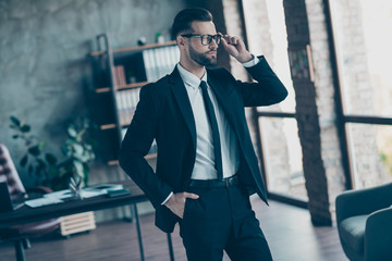 Wall Mural - Photo of successful hot business guy self-confident person looking side deep thinking chief wear specs black blazer shirt tie pants belt suit costume standing office indoors