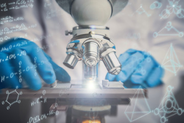 Wall Mural - close-up shot of microscope with metal lens. chemical formulas effects