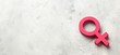 © adragan - Gender symbols of a woman of pink color on a gray background