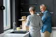 © LIGHTFIELD STUDIOS - smiling man and woman unpacking box in new house