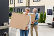 © LIGHTFIELD STUDIOS - mature man and smiling woman bringing boxes to new house