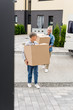 © LIGHTFIELD STUDIOS - mature man and smiling woman bringing boxes to new house