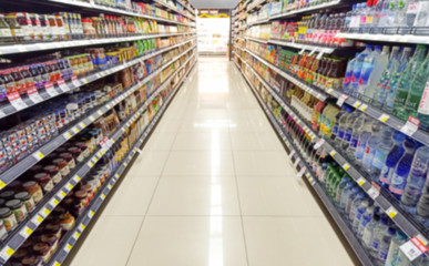 Wall Mural - Blurred Background Abstract Bokeh Shelving unit in Shopping store supermarket look at the lights .