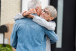 © LIGHTFIELD STUDIOS - smiling woman holding keys of new house and hugging mature man