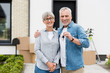 © LIGHTFIELD STUDIOS - mature man holding keys of new house and hugging smiling woman