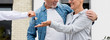 © LIGHTFIELD STUDIOS - panoramic shot of broker giving keys of new house to smiling man and woman