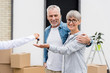 © LIGHTFIELD STUDIOS - cropped view of broker giving keys of new house to smiling man and woman