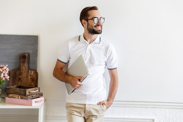 Poster - Attractive smiling young man standing at the wall