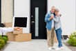 © LIGHTFIELD STUDIOS - selective focus of broker holding digital tablet and couple standing near new house on background