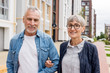© LIGHTFIELD STUDIOS - mature man and smiling woman looking at camera near new buildings