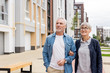 © LIGHTFIELD STUDIOS - mature man and smiling woman walking near new houses