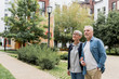 © LIGHTFIELD STUDIOS - mature man and smiling woman looking away near new buildings