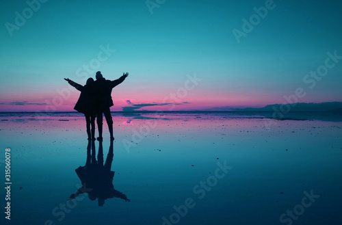 Surreal Pop Art Style Silhouette Of Couple Raising Arms Enjoy The Mirror Effect Of Uyuni Salt Flats Bolivia South America Buy This Stock Photo And Explore Similar Images At Adobe Stock