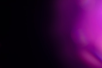 Wall Mural - purple flare on a black background. light for design