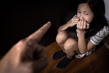 Sad Asian Child Girl Sit On Floor,feel Fear,pain,cry, Stop Physical Abuse And Domestic Violence, Angry Man Or Father Scolds Frightened Daughter,campaign Against Violence And Aggression Concept.