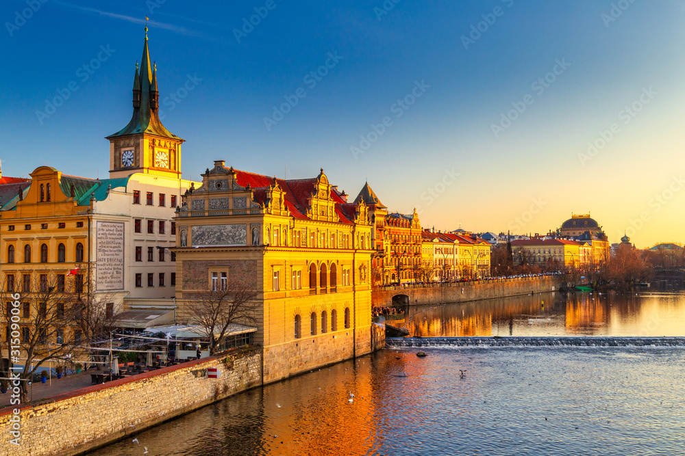 Historic buildings on the Vltava river bank at sunset in Prague, Czech Republic, Europe. - obrazy, fototapety, plakaty 
