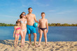 © Andrii - Happy family at the beach on a sunny day. Family vacation. Healthy lifestyle concept.