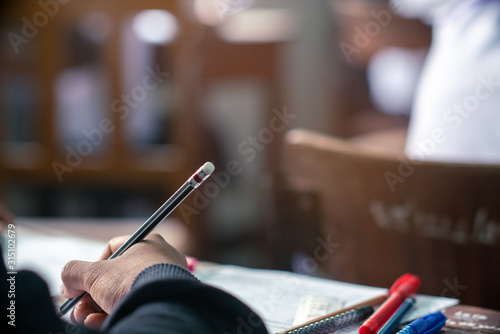 Cuadros en Lienzo Hand of Student doing test or exam in classroom of school with stress