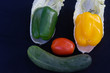 The vegetables on the smiley face are turnips, bell peppers, tomatoes and cucumbers.