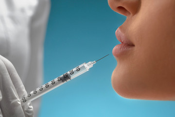 Cosmetic botox injection in lips.