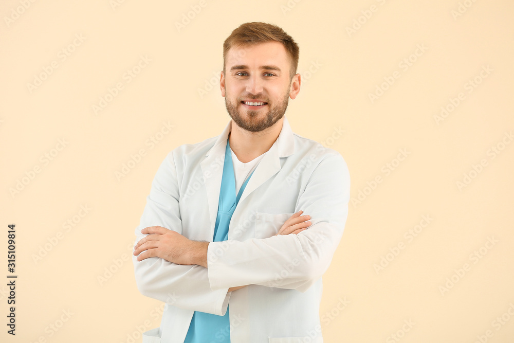 Portrait of male doctor on light background