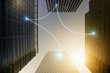 © Anthony Lee/Caia Image - Fiber optic light communication connecting highrise buildings, concept