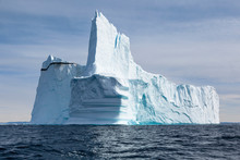 Majestic Towering Iceberg On Sunny Blue Atlantic Ocean Greenland