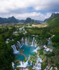 Massive hidden waterfall surrounded by mountain with blue clean water. Paradise on the border between China and Vietnam. Ban gioc waterfall, Detian.