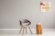 © Photographee.eu - Stylish grey wooden chair in empty living room interior with trendy wooden coffee table