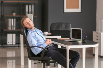 Canvas Print - Handsome businessman sleeping in office