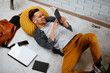 © JustLife - Young man having break from work and listens music. Businessman using smartphone.  Student listening music while studying.