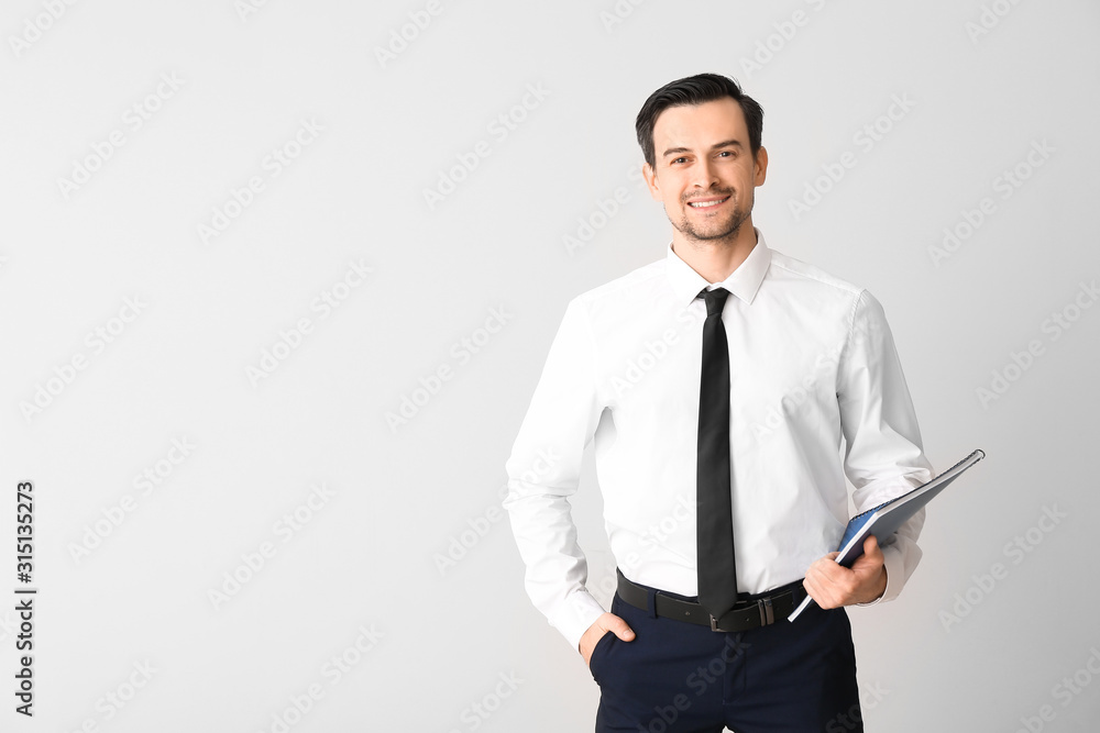 Male real estate agent on light background