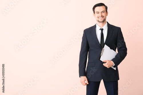 Cuadros en Lienzo Male real estate agent on color background