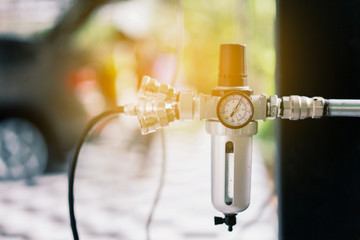 Closeup of a pressure meter on a machine, for checking air pressure and filling air in the tires with Car eletric pump
