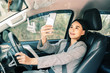 © Have a nice day  - Asian woman talk by mobile calling texting and looking on a cellular phone while sitting in her car, driving under the influence, the driver is safely talking by smartphone in a car concept