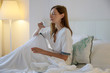 © triocean - Serene woman drinking coffee in the bed, casual relaxing time alone