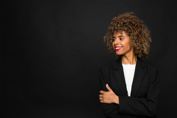 young woman african american  against flat wall