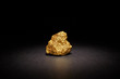 Closeup of big gold nugget on black background