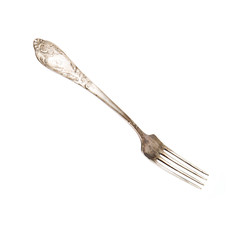 Silver old vintage fork on a white background