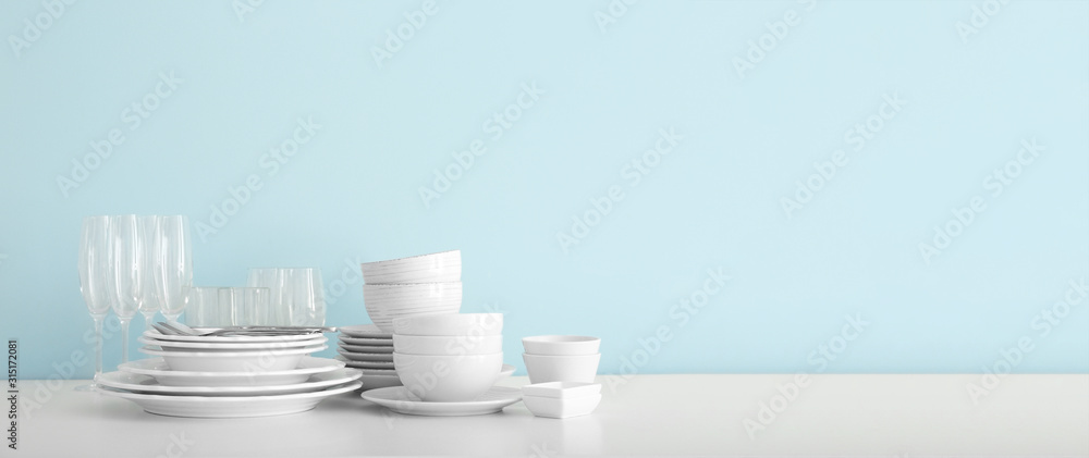 Set of clean dishware on table with space for text - obrazy, fototapety, plakaty 
