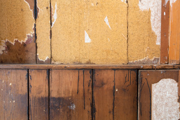 Wall Mural - background texture of a old destroyed wall with vintage torn wallpaper and old wood, abandoned house