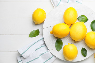 Fresh ripe lemons on white table