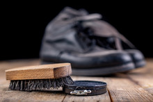 Polishing Of Military Boots On A Wooden Table. Maintenance And Protection Of Leather Shoes.