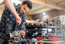 Mechanic Fixing Car Engine In Auto Repair Shop