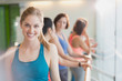 © Justin Pumfrey/Caia Image - Portrait smiling woman in exercise class gym studio