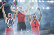 © Chris Ryan/Caia Image - Enthusiastic male gymnasts celebrating victory on winners podium